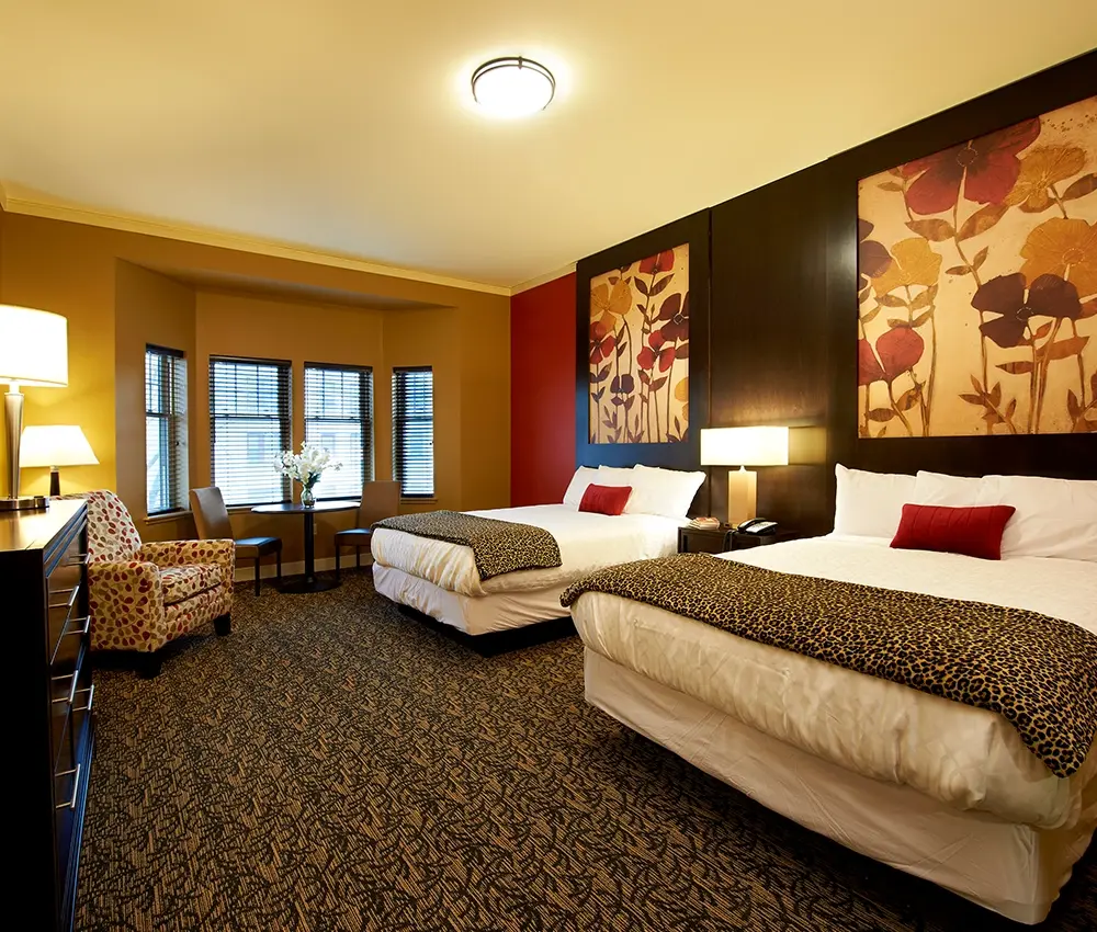 A guest room with two double beds