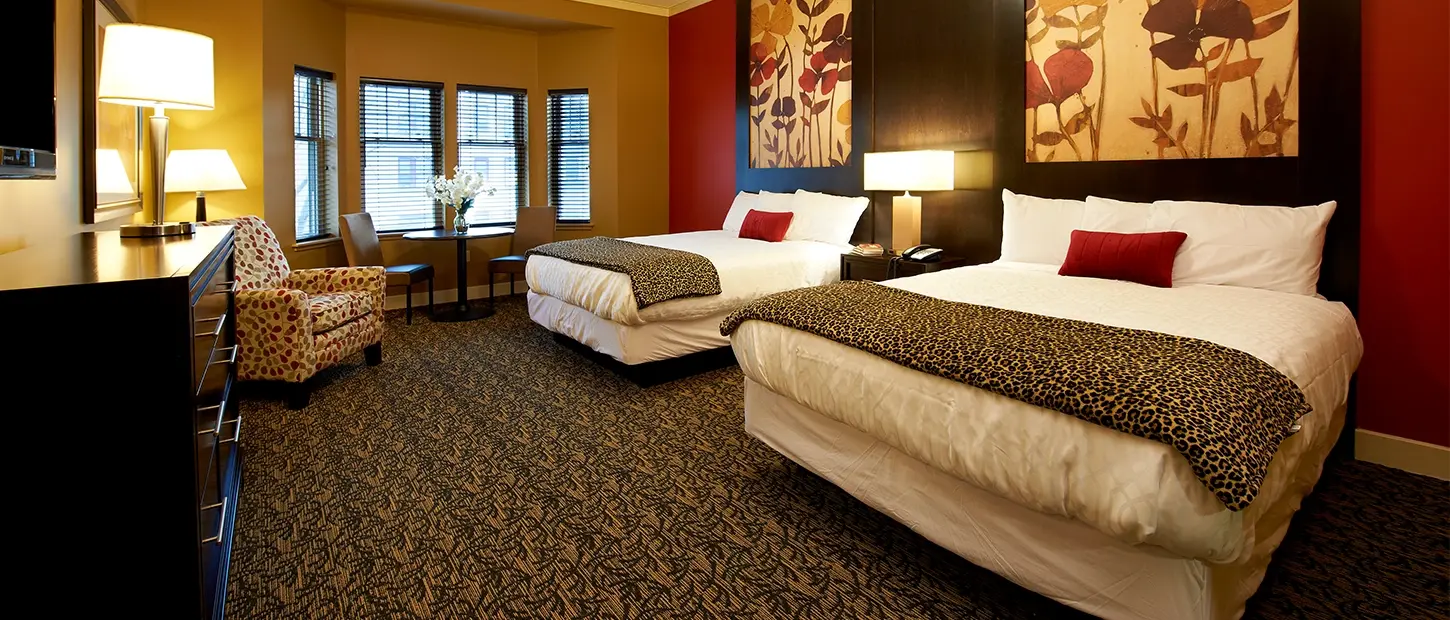 A guest room with two double beds